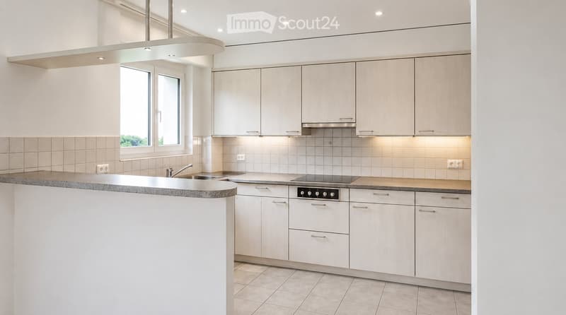 Modern kitchen with white cabinets, granite countertop, stainless steel sink and stove, and built-in lighting.