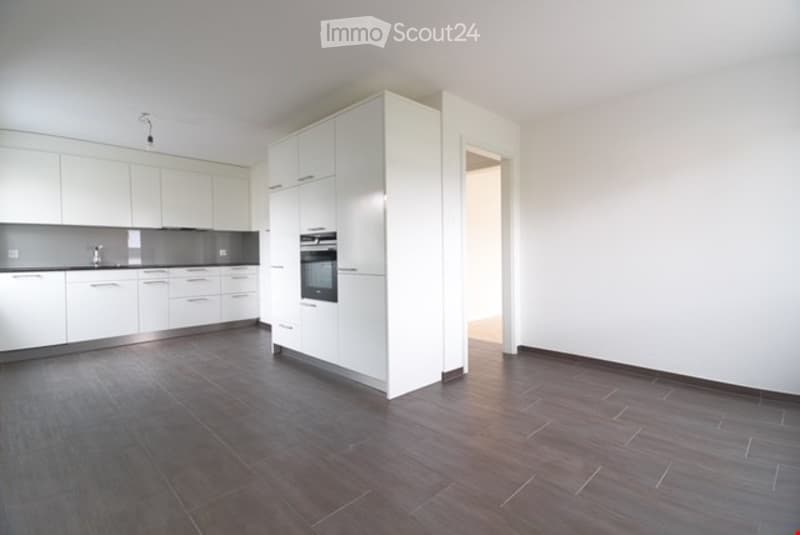 modern kitchen with white cabinets, gray tiled floor, built-in oven, sink with faucet