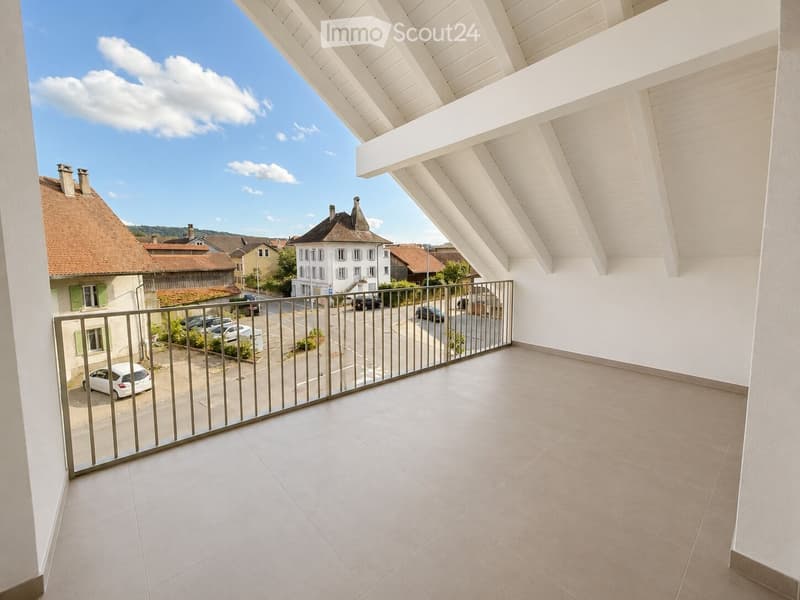 Balcony with white tiled flooring, metal railing, and a view of a street with parked cars and surrounding buildings.