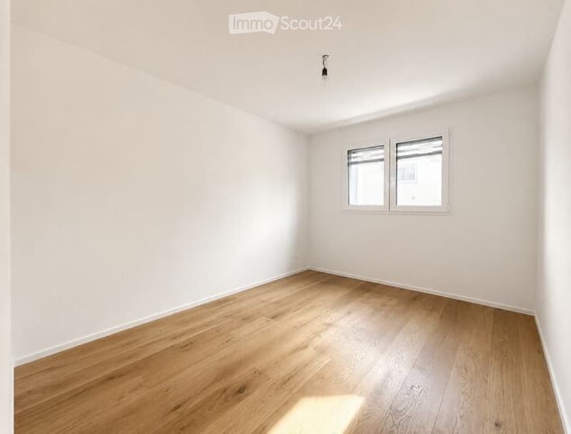 Completely empty room with bare white walls and wooden floor. No furniture or equipment.