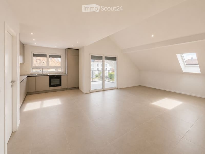 Empty room with tiled floor, white walls, and built-in kitchen area with cabinets, sink, and oven. Features large windows and a sliding glass door leading to a balcony.