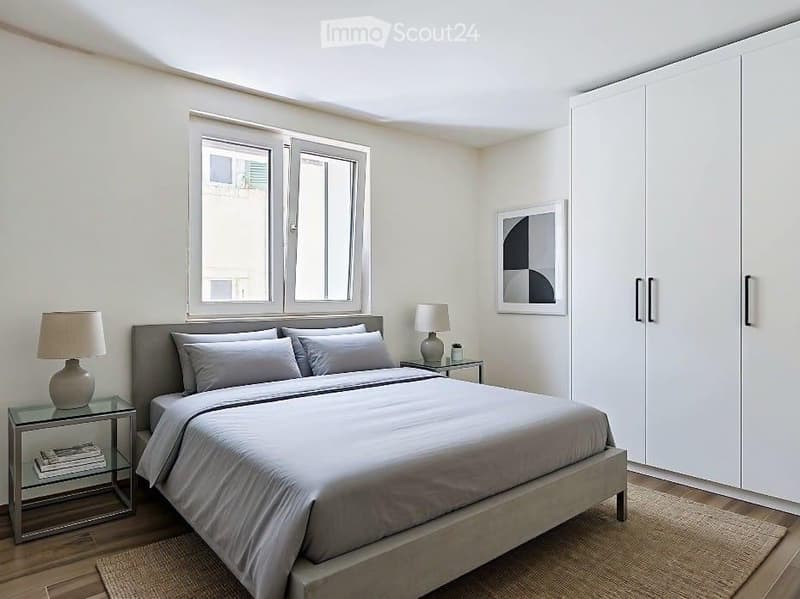 Modern bedroom with a large bed, nightstands, lamps, a picture frame on the wall, and a large wardrobe.