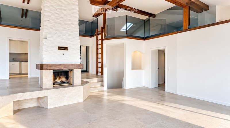 Modern living room with a large stone fireplace, wooden beams, and a glass-enclosed loft area above.