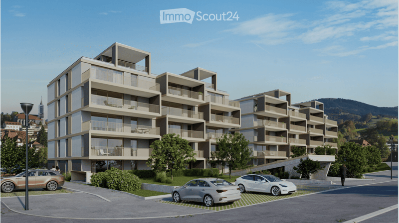 Modern multi-story residential building with balconies, surrounded by greenery and parked cars.