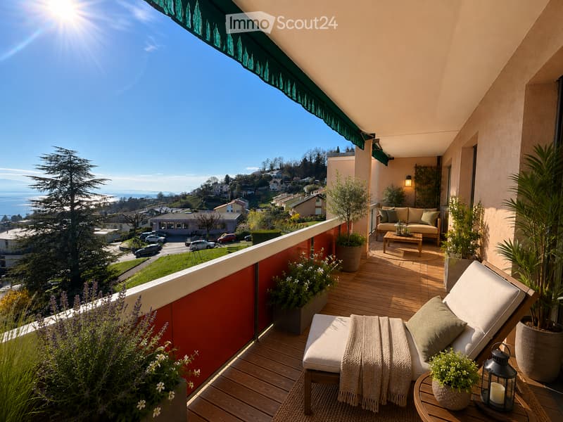 Balcony with wooden decking, lounge chair, sofa, coffee table, potted plants, and scenic view of the city and ocean.