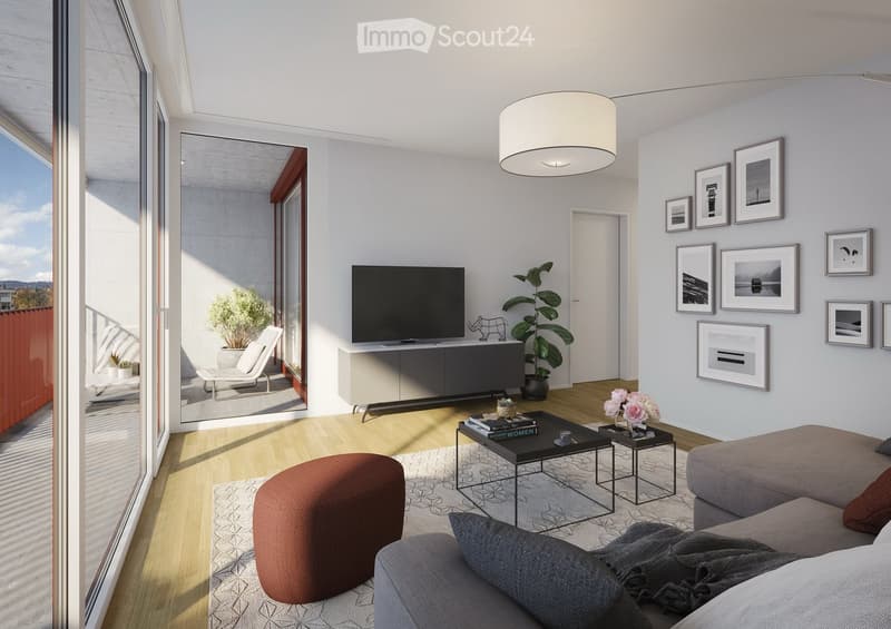 Modern living room with a grey sofa, ottoman, coffee table, side tables, television, cabinet, floor lamp, plant, and picture frames on the wall.