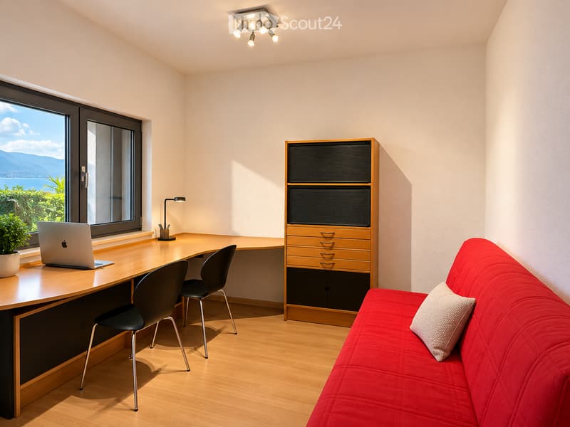 A modern, well-lit room with a red sofa, a wooden desk with a laptop, two black chairs, a wooden cabinet, and a potted plant near the window offering a scenic view.