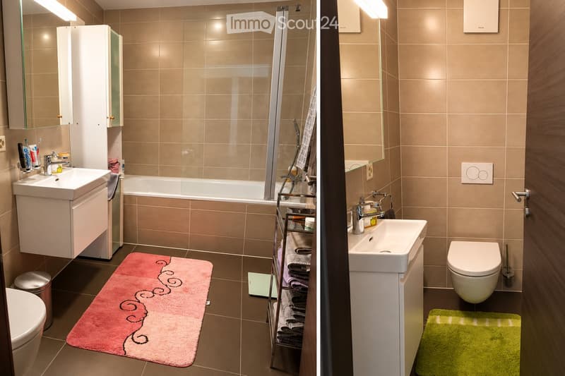 Two bathrooms with beige tiles, white fixtures, and modern design. The left bathroom features a sink, bathtub, and a pink rug. The right bathroom includes a sink, toilet, and a green rug.