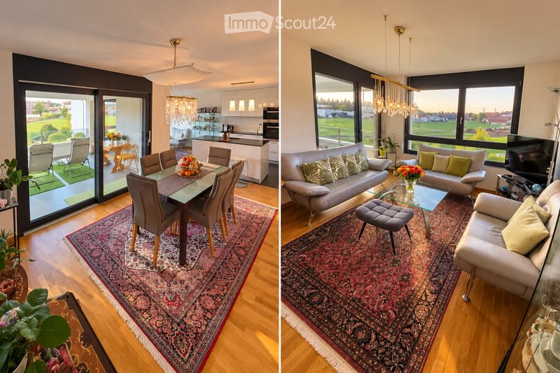 Two connected rooms: living room with a sofa, coffee table, and pendant light; dining area with a table, chairs, and a fruit bowl. Large windows and a view of the outdoors.