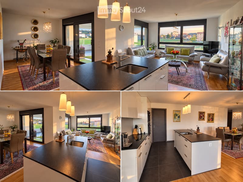 Modern open-plan living and dining area with a kitchen island, large windows, pendant lights, and contemporary furniture including a sofa, dining table, and chairs.
