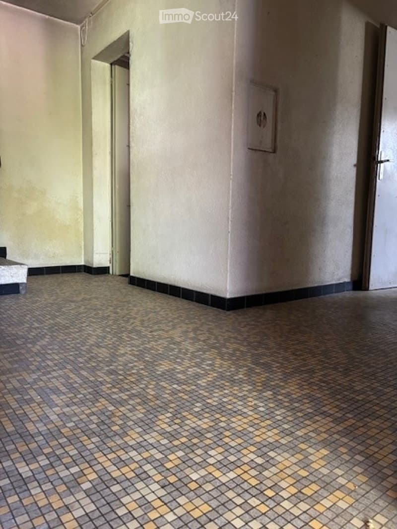 Empty room with patterned tile flooring and white walls. No furniture or equipment present.