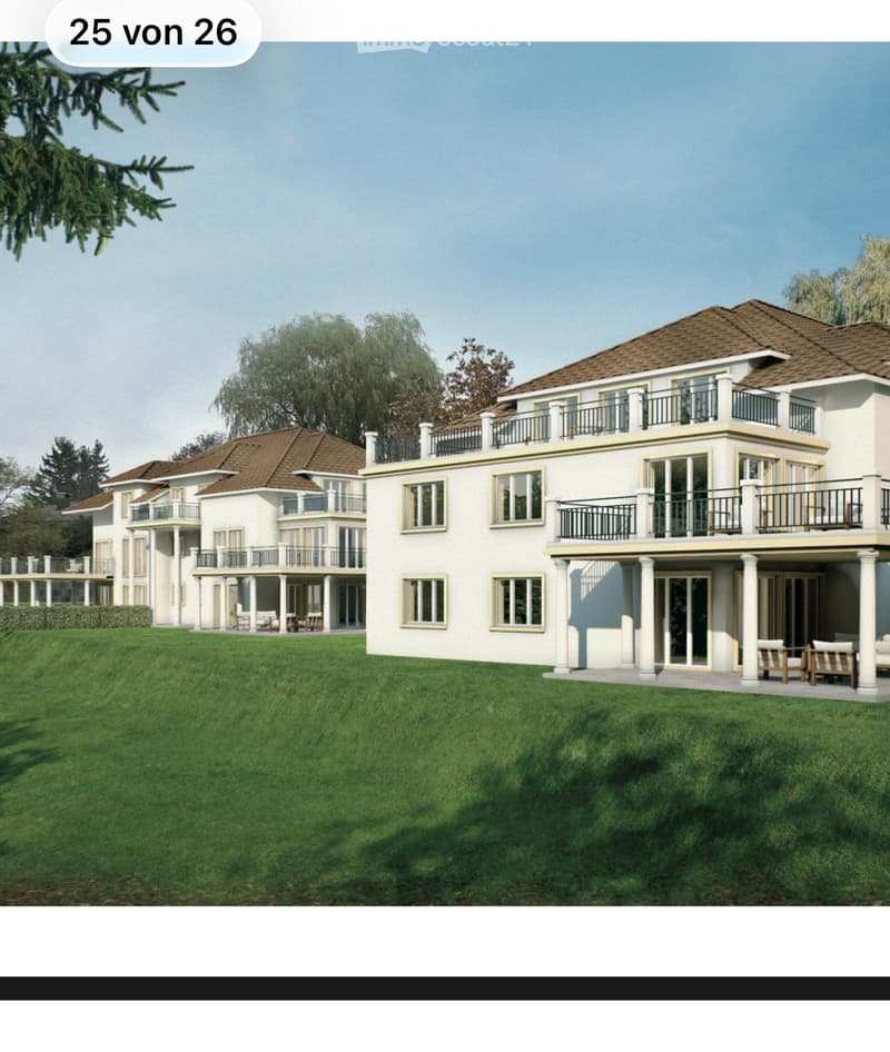 Large, modern two-story house with white exterior, multiple balconies, and a spacious lawn.