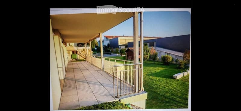tiled floor balcony, metal railing, outdoor area with grass and plants