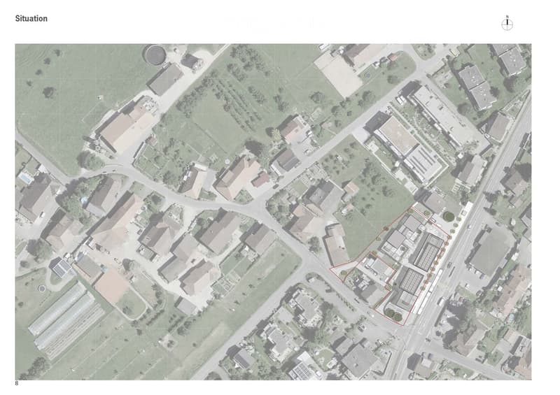 Aerial view of a residential area with multiple houses, roads, and green spaces. The highlighted area shows a specific building with a red outline.