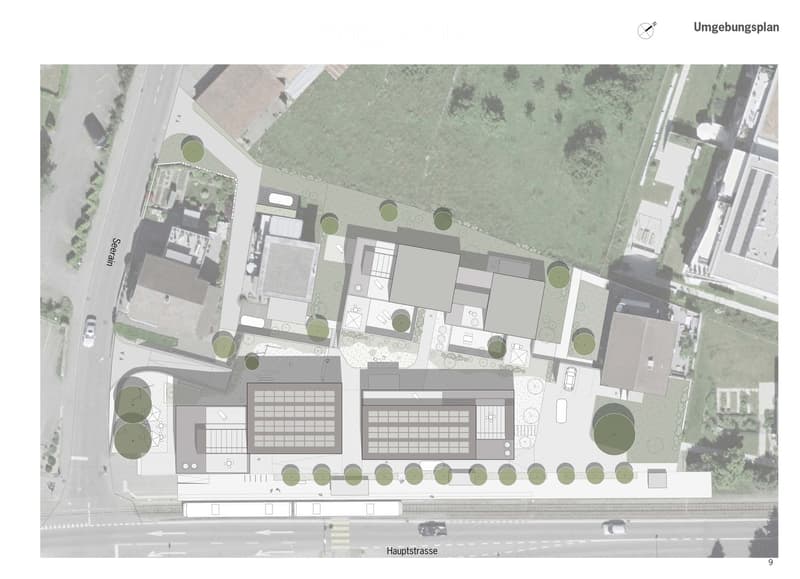 A detailed floor plan of a residential area showing multiple buildings, green spaces, and parking areas. The layout includes various structures, pathways, and landscaped areas.