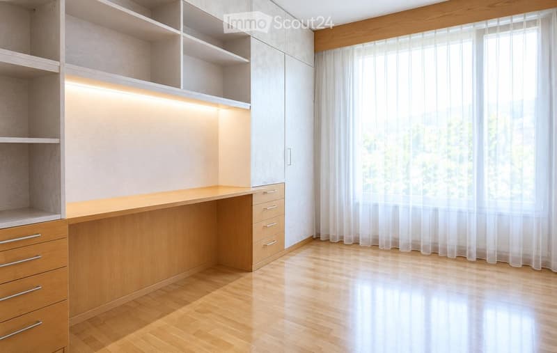 Empty room with wooden flooring, built-in shelves, and a large window with sheer curtains.