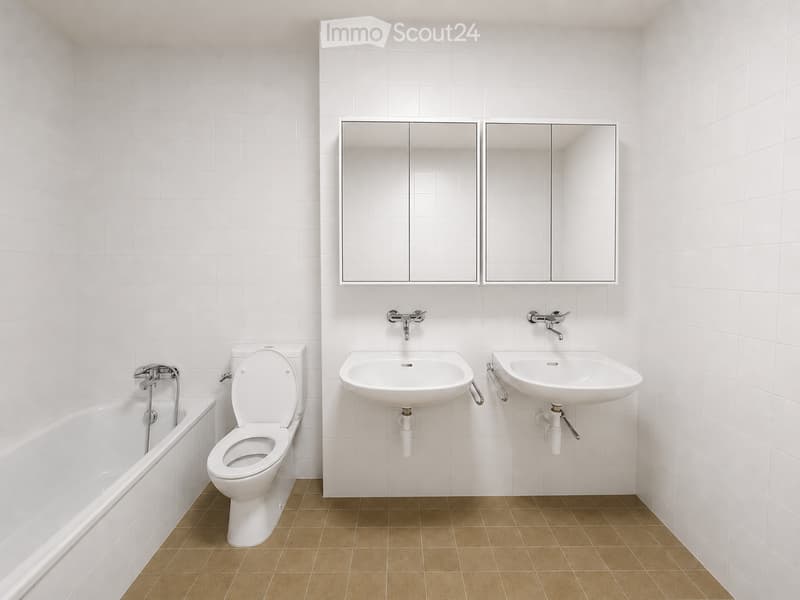 Modern bathroom with white tiled walls, brown tiled floor, bathtub, toilet, two sinks, and mirrored cabinet.