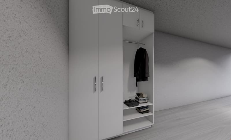 Empty room with white walls, light wooden floor, and a large white wardrobe with mirrored doors. The wardrobe contains a few folded clothes and a jacket hanging on a rod.