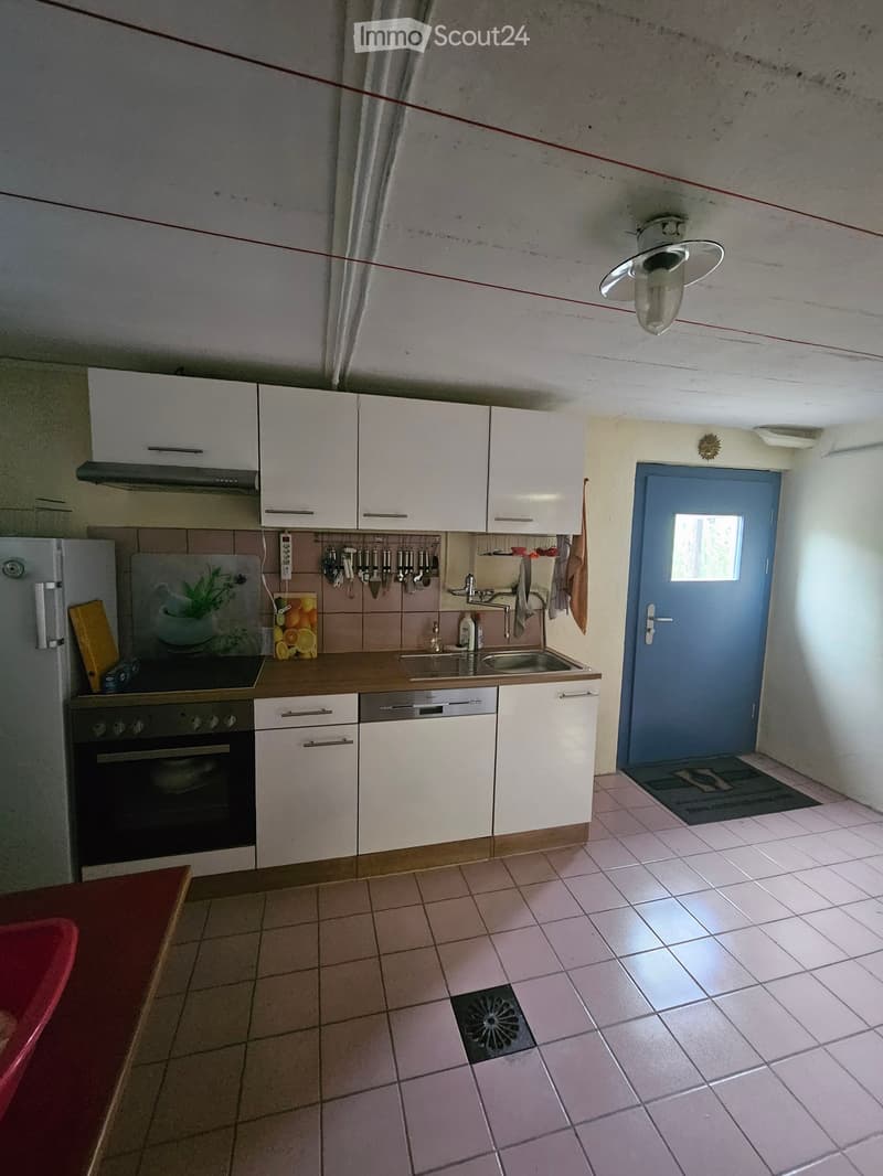 Modern kitchen with white cabinets, stainless steel appliances, and tiled flooring. Features include a refrigerator, oven, dishwasher, sink, and various kitchen utensils.
