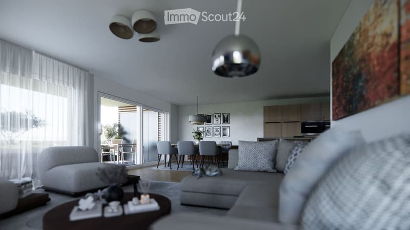 Modern open-plan living and dining area with grey sofa, coffee table, dining table with chairs, kitchen cabinets, pendant lights, and artwork on the wall.