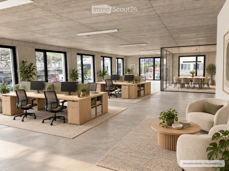 Modern office space with wooden desks, ergonomic chairs, computer screens, a round coffee table, a sofa, and several potted plants. Large windows provide natural light, and the space is organized with a mix of work and relaxation areas.