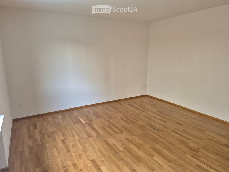 Empty room with light-colored walls and wooden flooring, no furniture or equipment present.
