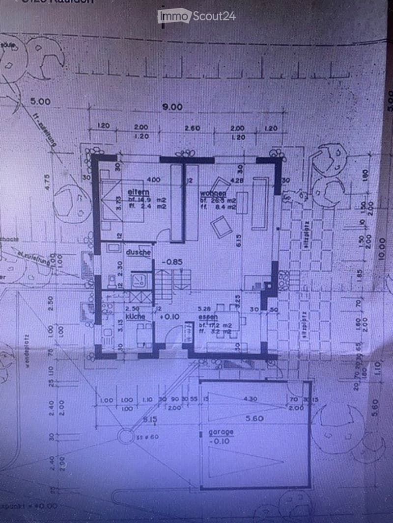 Floor plan of a residential unit showing a living room, kitchen, two bedrooms, two bathrooms, and a garage.