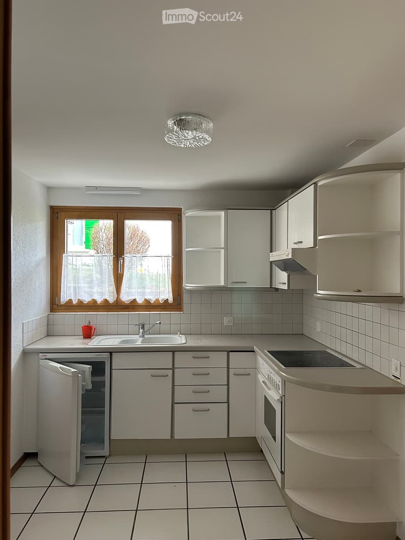 modern kitchen with white cabinets, tiled floor, sink, stove, refrigerator, window with curtains