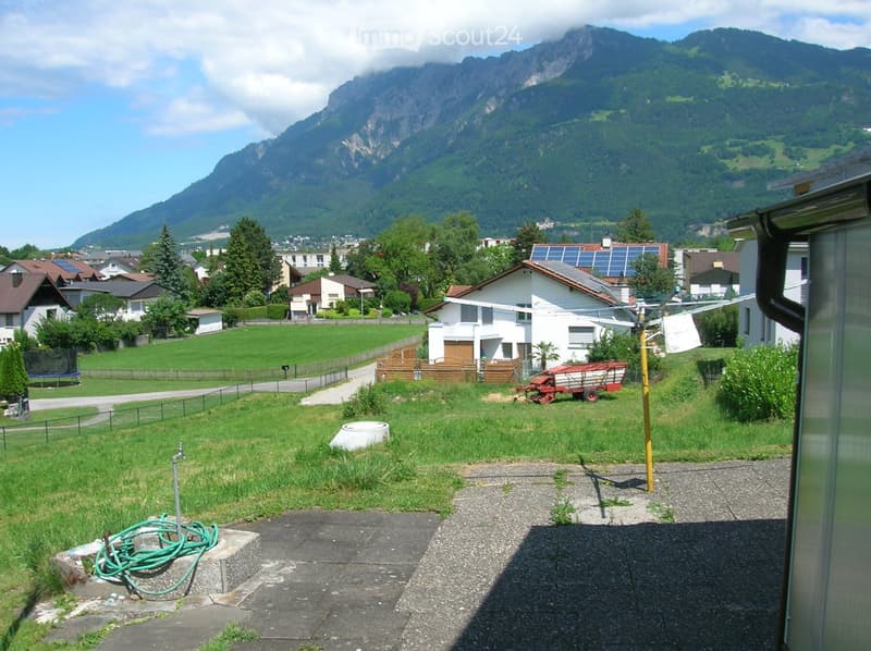 House with solar panels, garden, mountain view