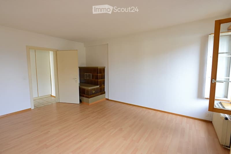 Empty room with wooden flooring, white walls, and a small cabinet in the corner. No furniture or equipment is present.