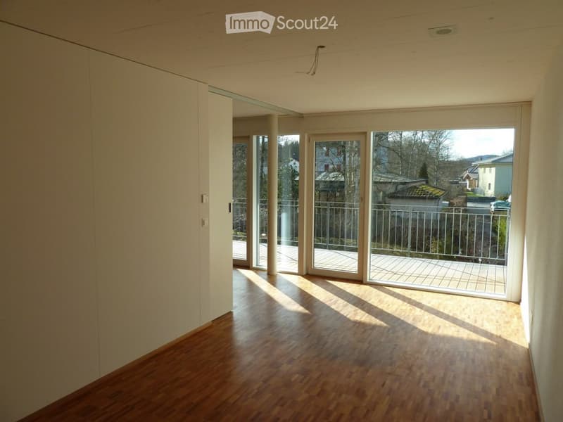 empty room, wooden floor, glass sliding doors, balcony, white walls