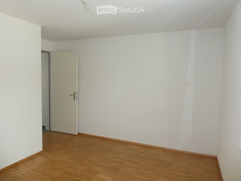 empty room, white walls, wooden floor, white door, small window