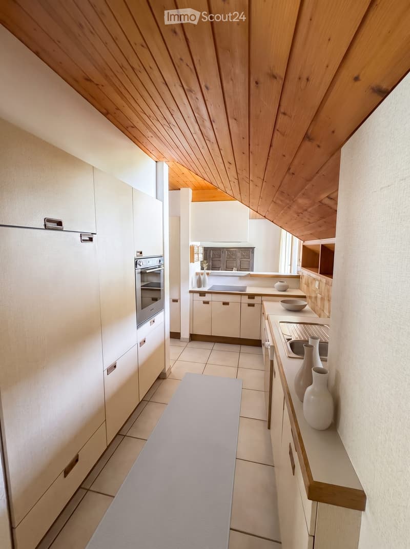 Modern kitchen with white cabinets, wooden ceiling beams, tiled floor, and decorative vases on the counter.