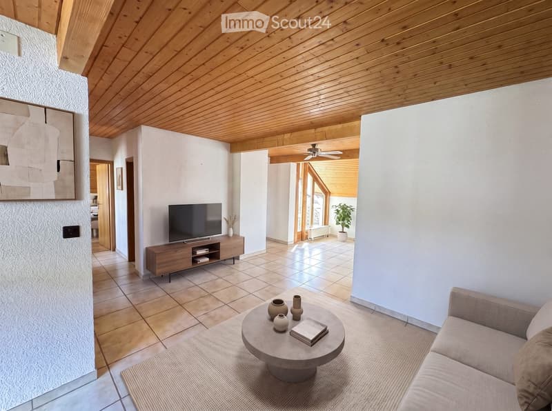 Modern living room with a wooden ceiling, tiled floor, and large windows. Features a sofa, coffee table, TV stand, and decorative vases.