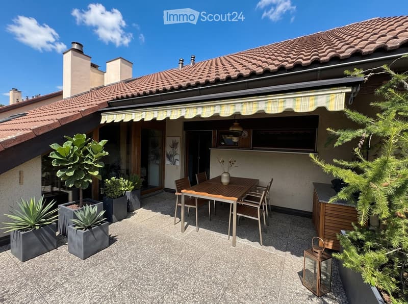 Outdoor patio with a wooden dining table, chairs, potted plants, and a lantern, attached to a house with a tiled roof and striped awning.