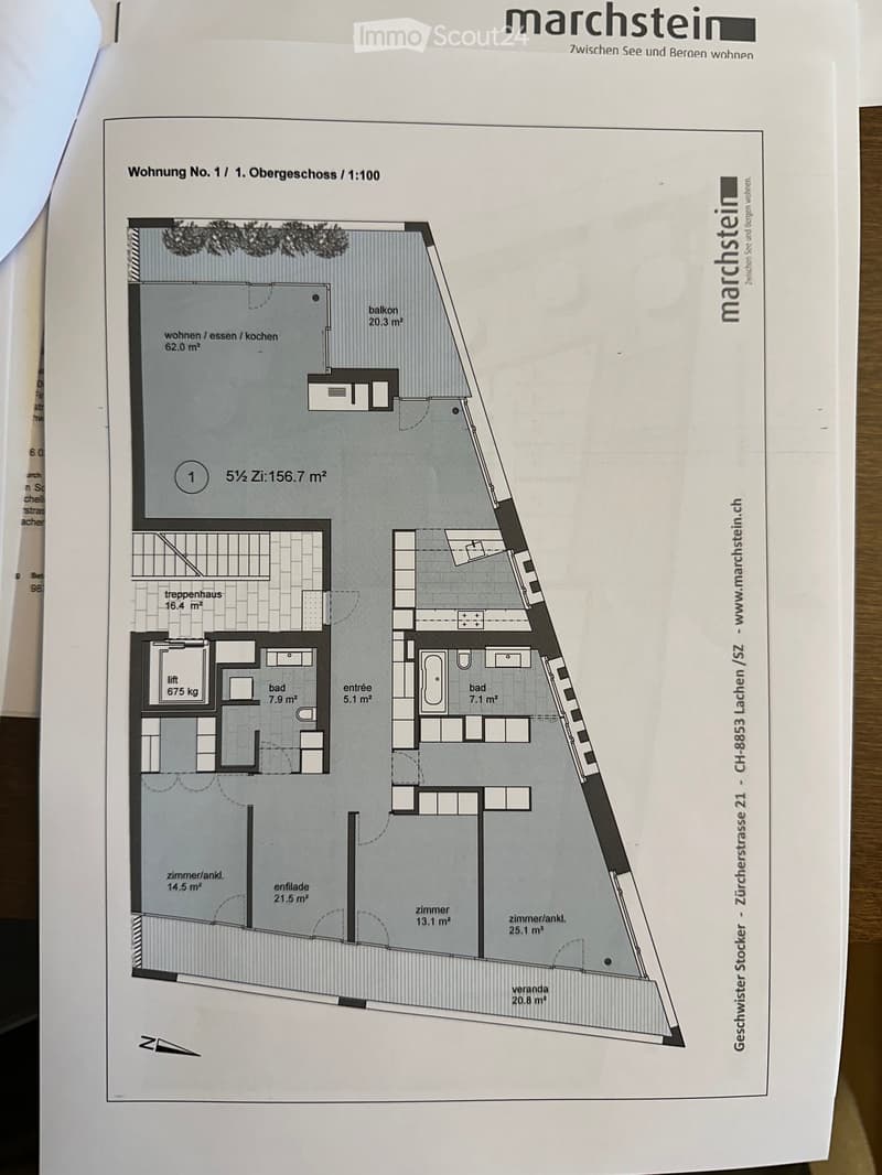 Floor plan of a 1st-floor apartment with a combined living/dining/ kitchen area, two bedrooms, two bathrooms, a staircase, and a balcony.