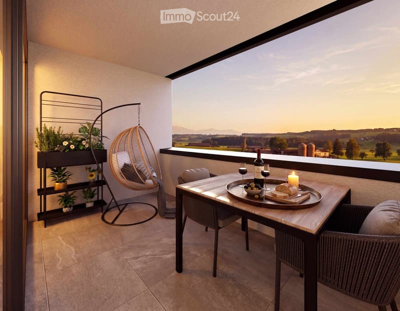 Balcony with a scenic view, featuring a wooden table, wicker hanging chair, potted plants on a shelf, and a tray with wine, bread, and a candle.