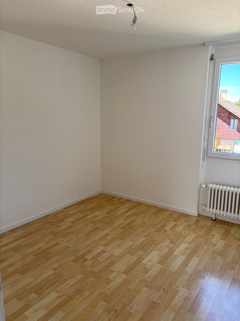 Empty room, wooden floor, white walls, window