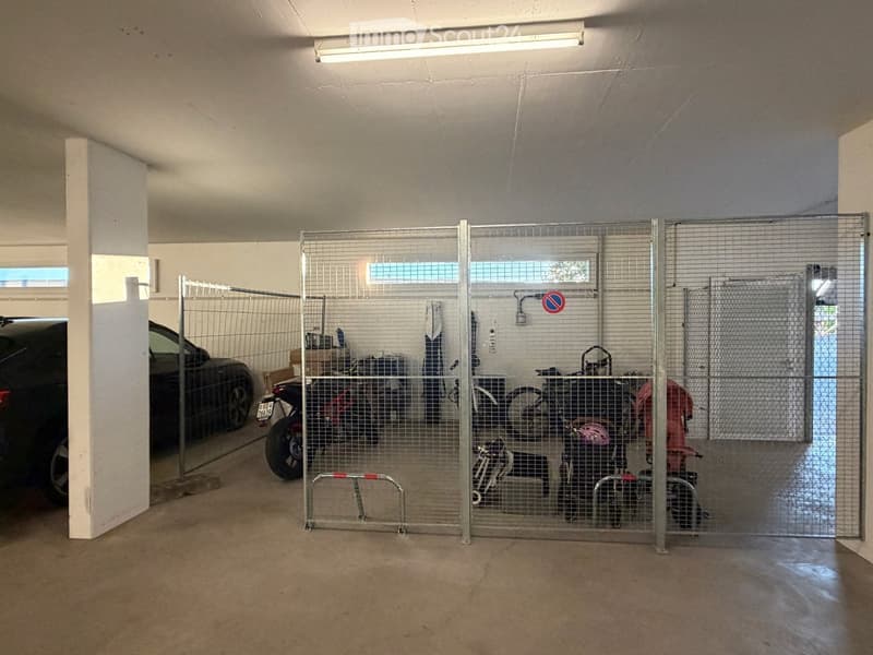 {"type": "Garage", "objects": [], "description": "Underground garage with concrete floor, fluorescent lighting, and metal security gates. Contains a parked car, motorcycles, and bicycles behind the gates.", "localized_descriptions": {"EN": "Underground ga