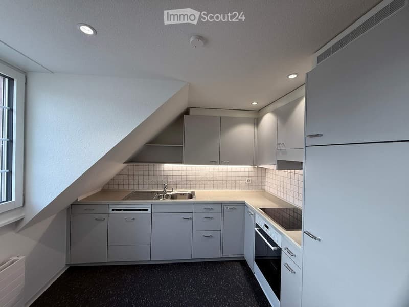 kitchen area, sink, oven, dishwasher, white cabinetry, black floor