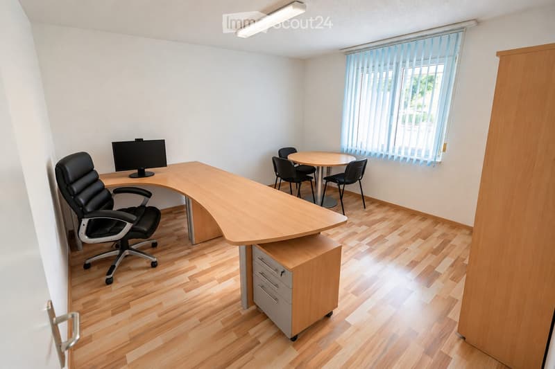 Office space with a large wooden desk, ergonomic chair, computer screen, small round table with four chairs, and a filing cabinet.