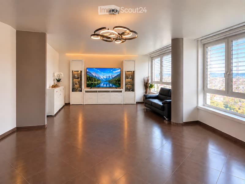 Modern living room with dark brown tiled floor, large windows, a black leather sofa, a flat-screen TV on a white cabinet, and decorative vases on side tables.