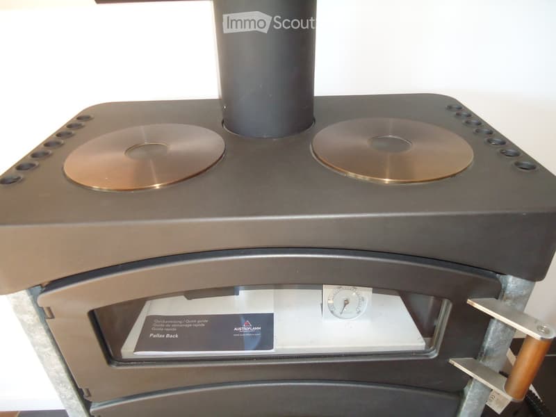 A close-up of a professional audio mastering station with two large copper discs and a gauge on the front panel.