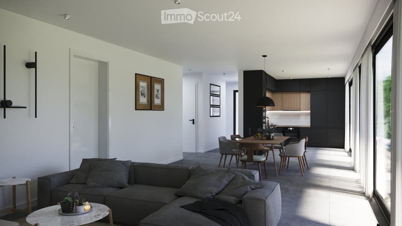 Modern open-plan living and dining area with a grey sectional sofa, coffee table, side table, dining table with chairs, pendant light, and kitchen area with dark cabinets.