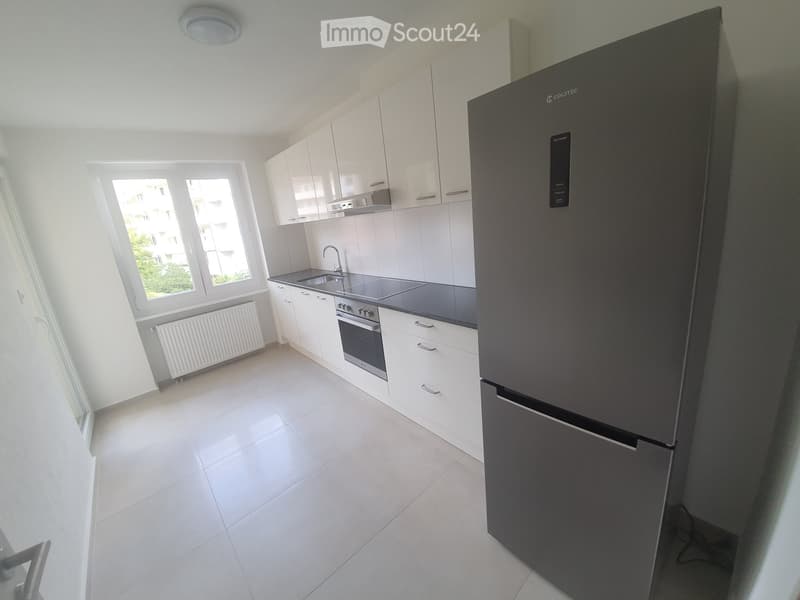 modern kitchen, white cabinets, tiled floor, stainless steel appliances, refrigerator, oven, sink, faucet, window