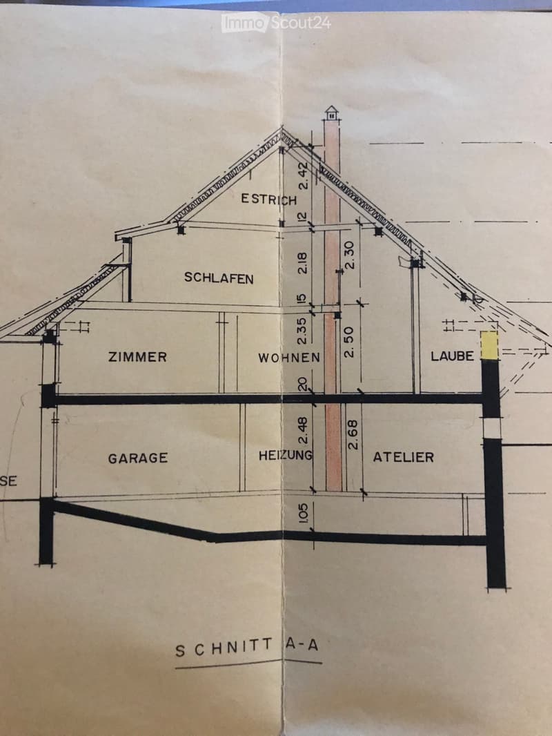 Floor plan showing a two-story house with labeled rooms: garage, heating, atelier, living, bedroom, and attic.