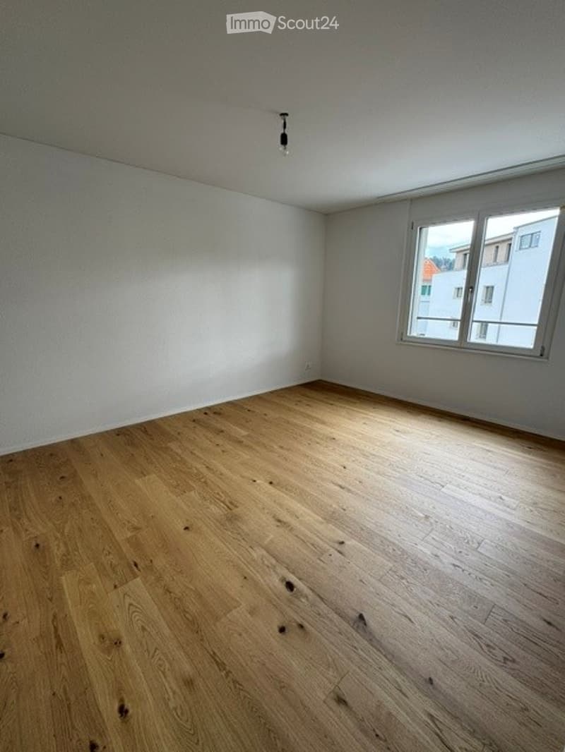 Completely empty room with bare walls and wooden floor. No furniture or equipment.