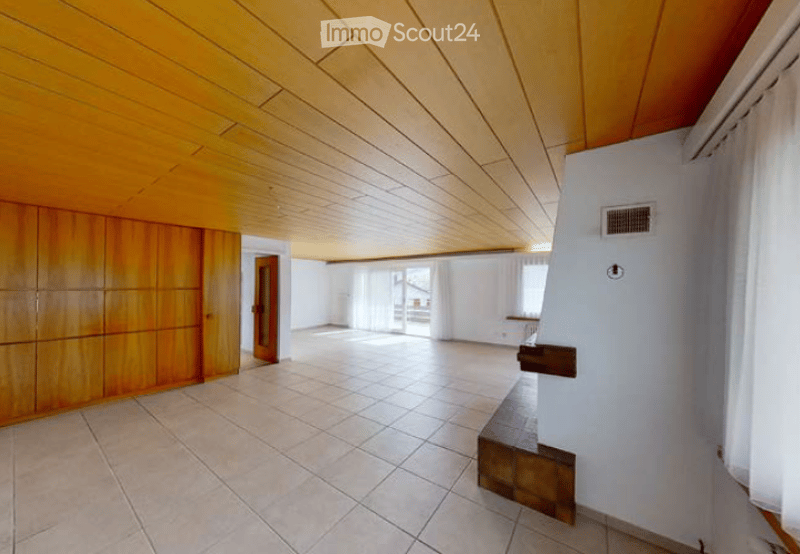 Empty room with wooden ceiling, tiled floor, large windows, and wooden cabinetry.