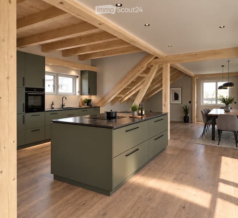Modern kitchen with green cabinets, central island, built-in oven, and dining area with table and chairs.