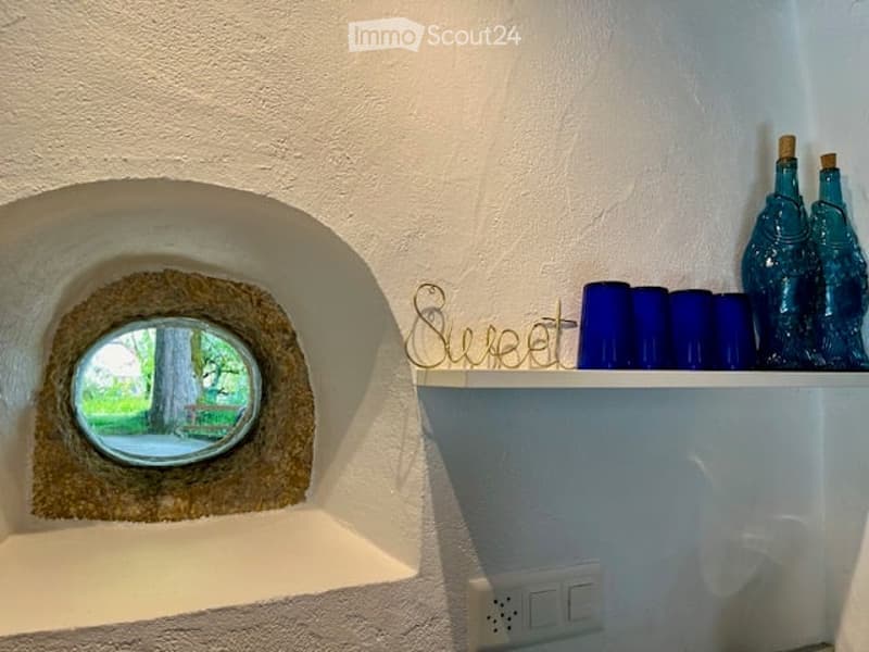 white walls, small window, round window with view, decorative item, blue glasses
